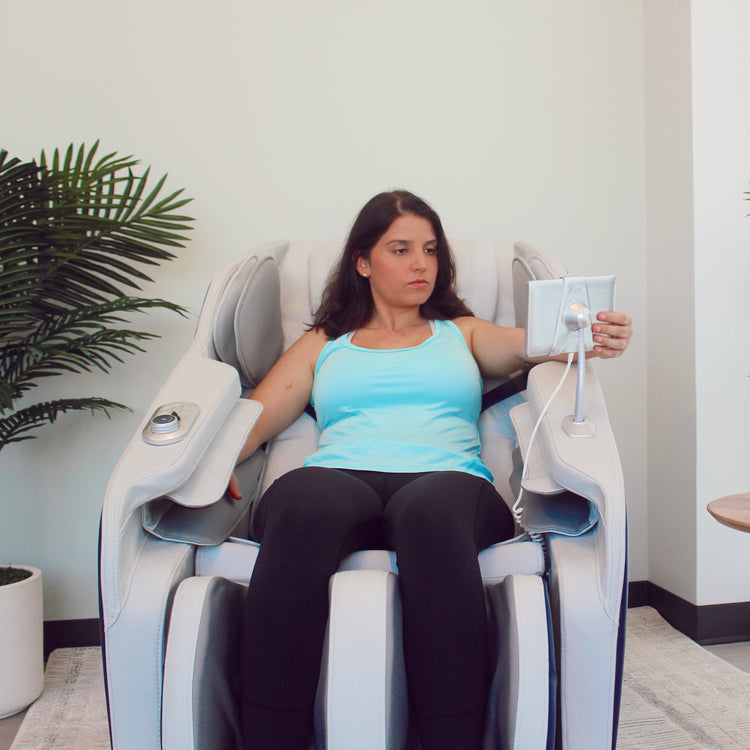 Woman enjoying a massage in white R8375 2D massage chair. 